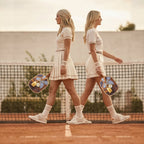 Elegant player on a luxury resort court holding the blue and brown Grand Trunk designer paddle from RallyStand mid-swing.